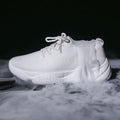 Women's white sports shoes with thick rubber soles and woven upper featuring lace-up front strap
