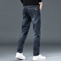 Blue grey and black slim straight loose casual thin trousers on a hanger, showing mid waist and zipper fly.