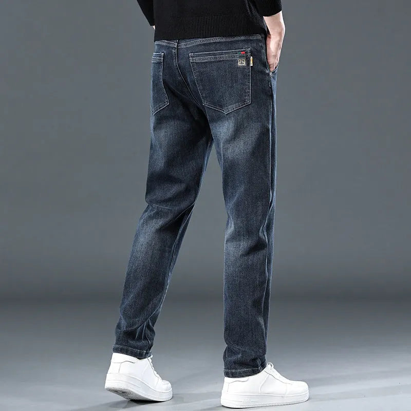 Blue grey and black slim straight loose casual thin trousers on a hanger, showing mid waist and zipper fly.