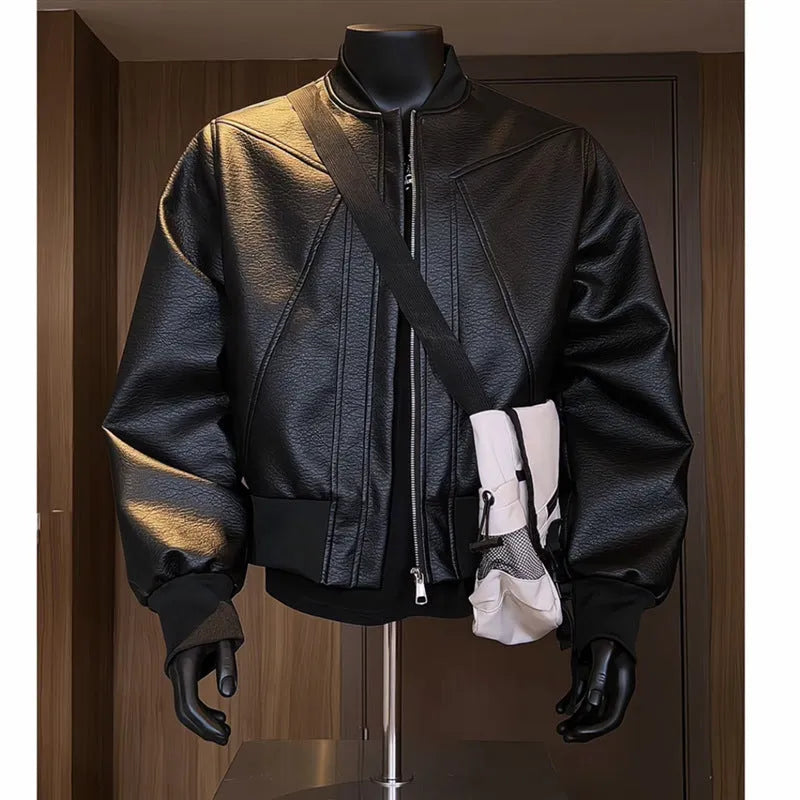 Man wearing a black slim-fit extended length PU leather jacket with a litchi pattern texture.