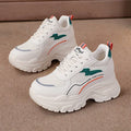 Women's white breathable mesh sports shoes with cross shoulder straps and built-in height increasing insoles.