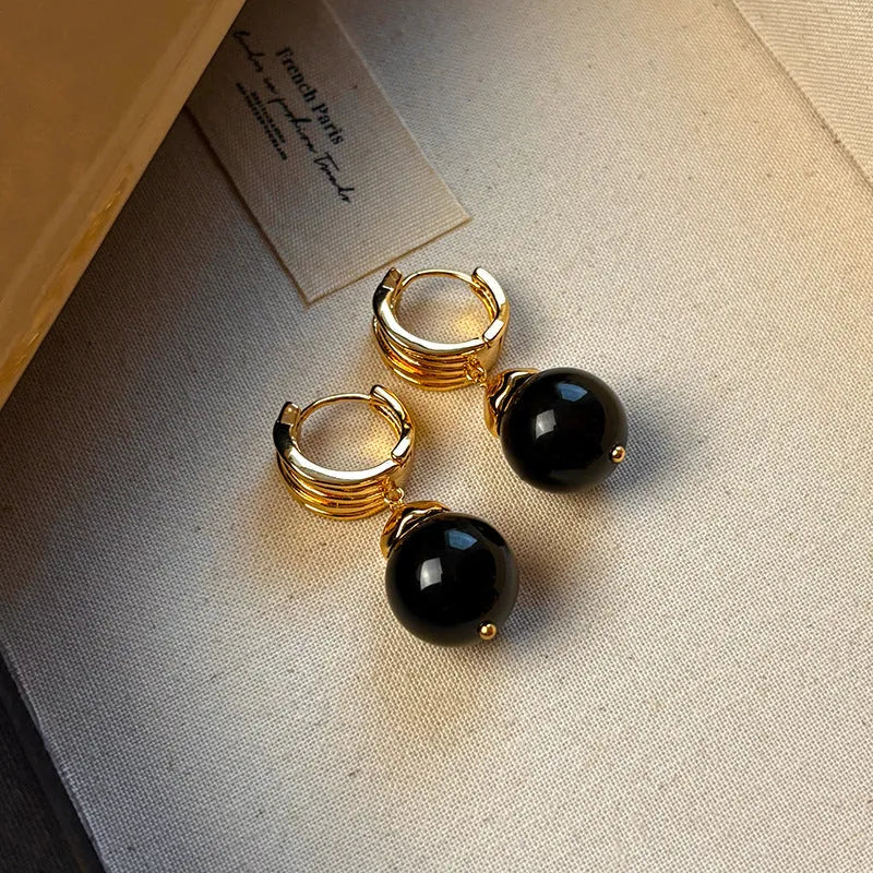Gold-plated geometric earrings made from brown and black Tigereye stone in a French retro style.