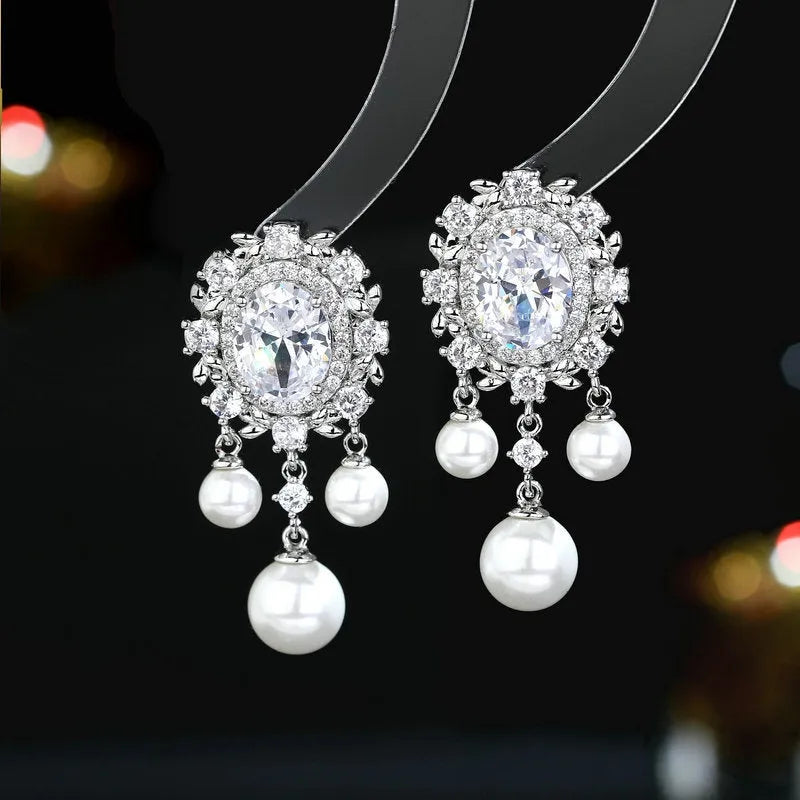 Oval zircon inlaid pearl tassel earrings in copper with geometric design and dangling elements