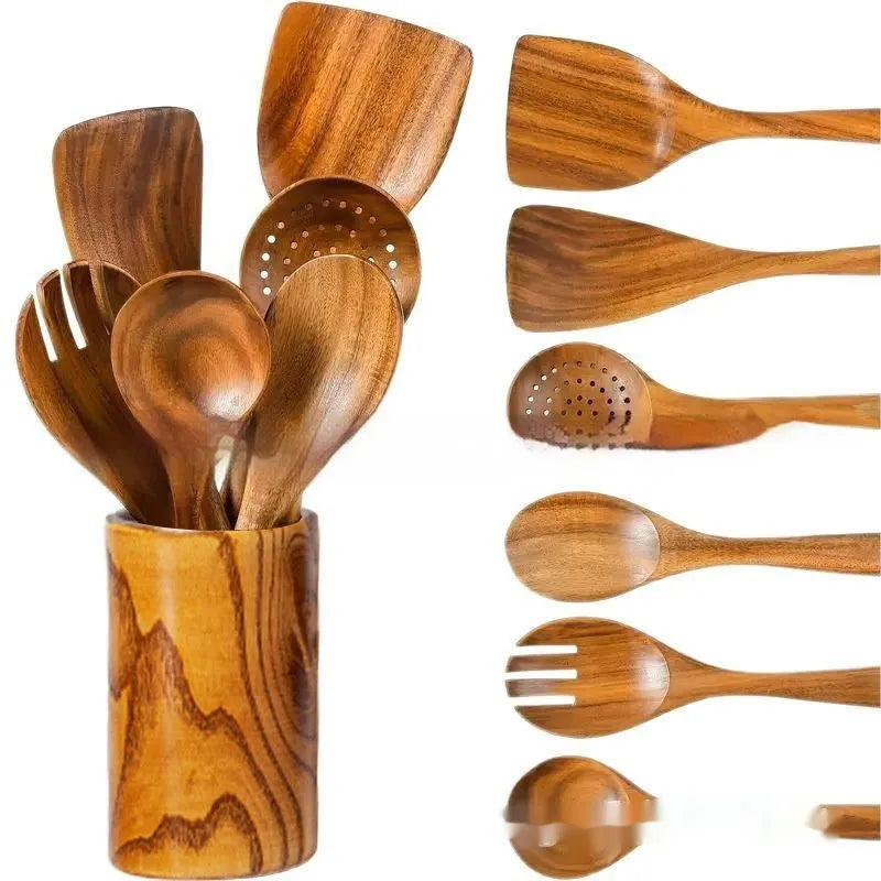 Boxed set of seven wooden kitchen spoons and spatulas on a table.