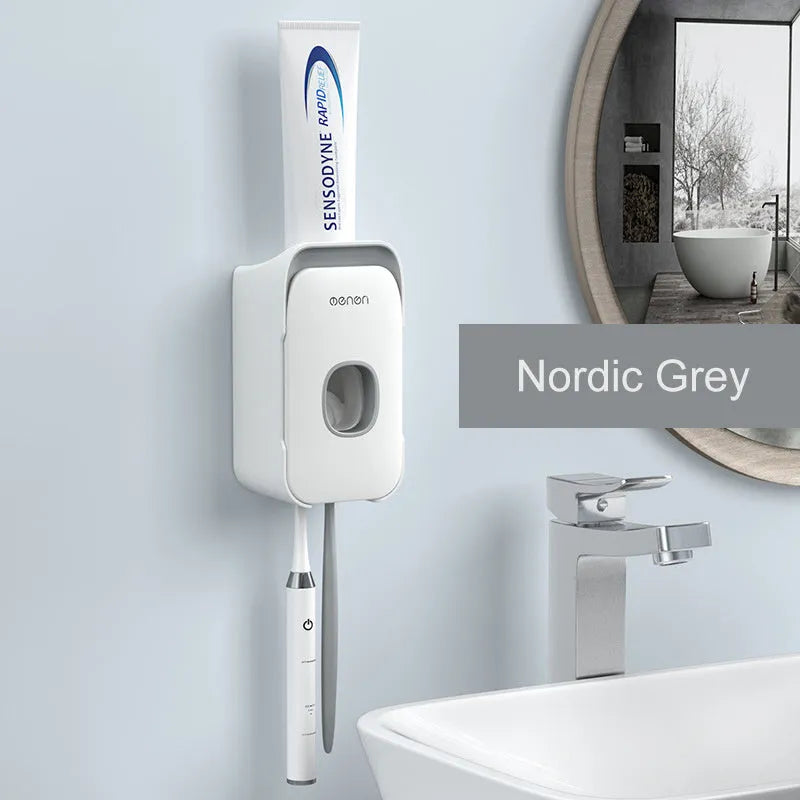Automatic wall-mounted toothpaste dispenser in blue, grey, and pink colours with USB charging cable.