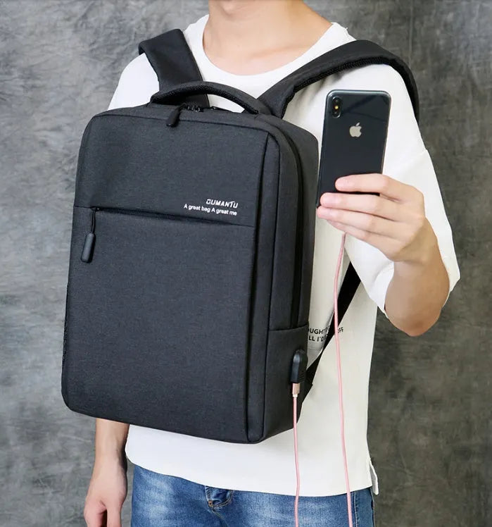 Black waterproof laptop backpack with USB port open, showing padded laptop compartment and internal pockets.