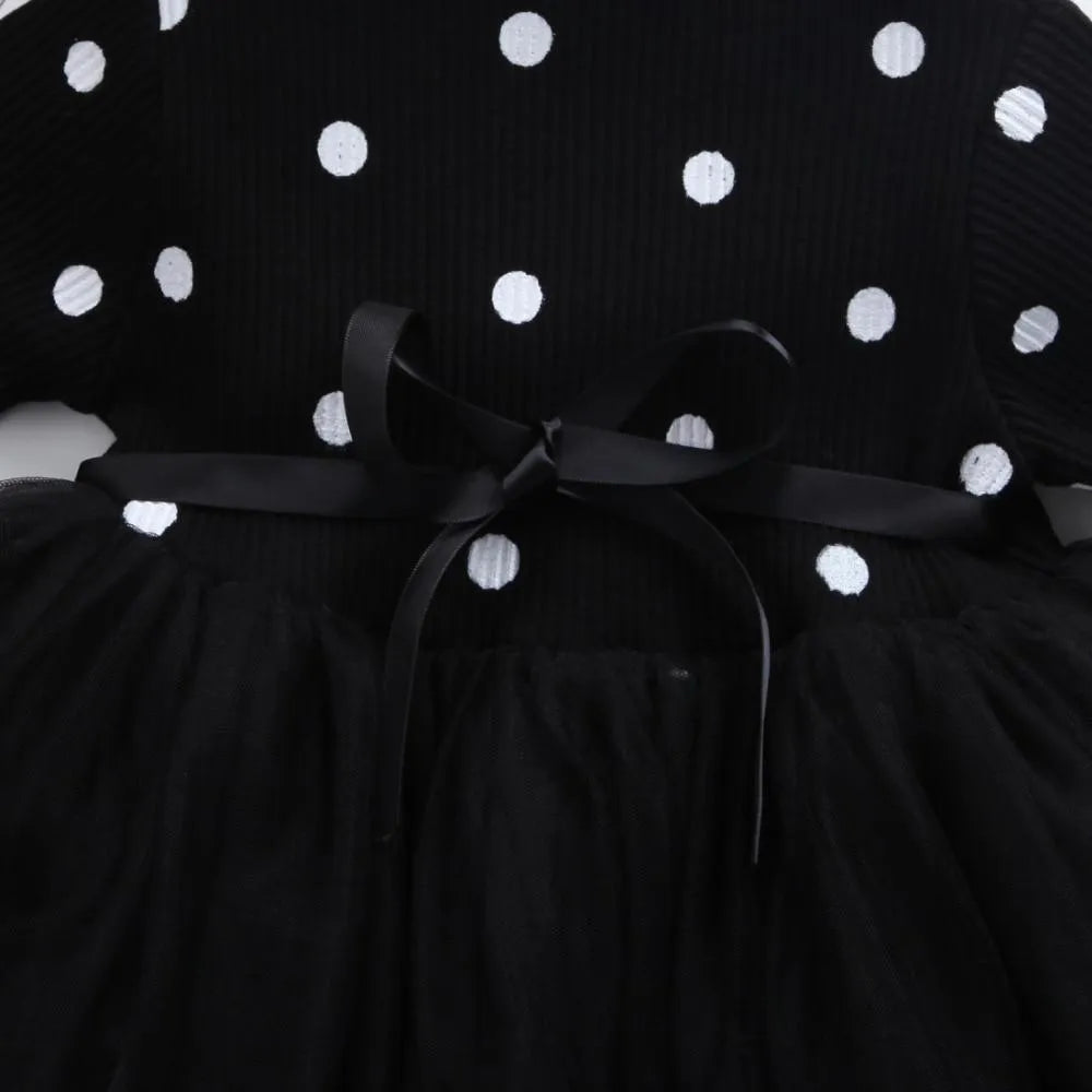 Baby girl wearing black lace tutu dress with long sleeves for birthday party