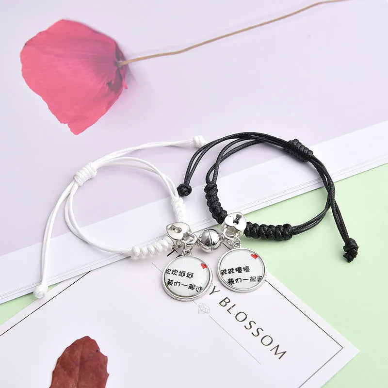 Pair of alloy suction bracelets with engraved symbol choices including crown, love lock, and clover.