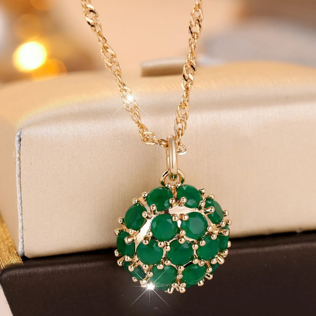Round emerald pendant necklace with full diamond detailing in champagne gold colour on chain