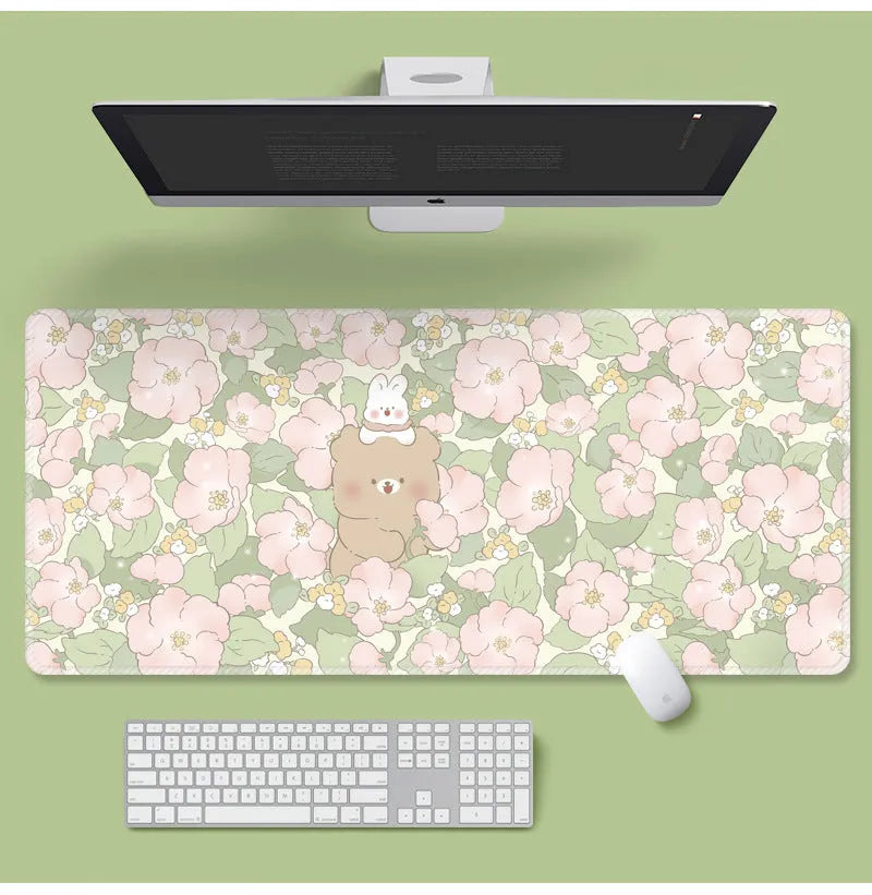 Large flower pattern mouse pad on a desk with keyboard, showing non-slip rubber base and colourful tulip design.