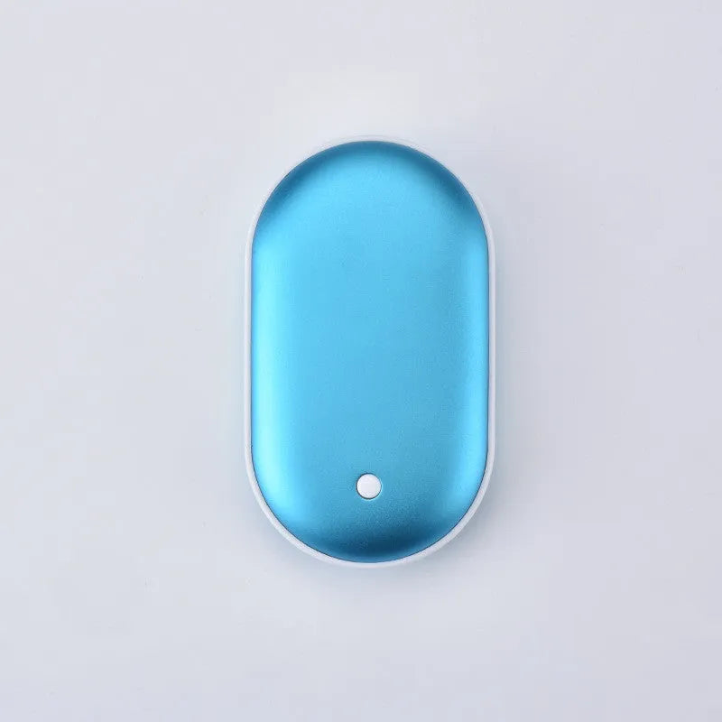 Compact rose gold USB rechargeable hand warmer and power bank with digital display on a wooden table.
