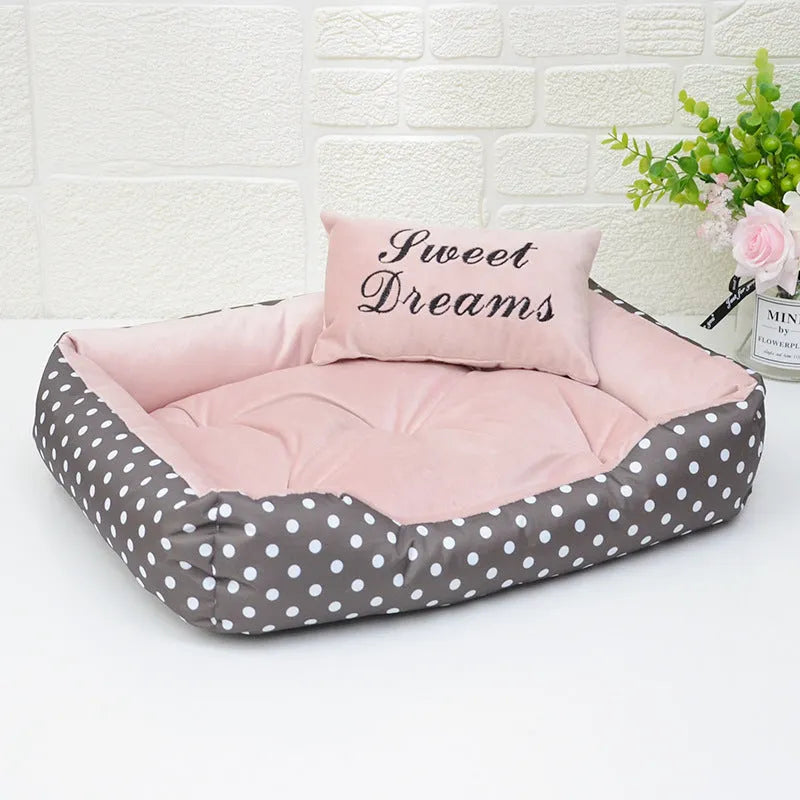 Polka dot print dog bed with a matching square pillow in grey, blue, pink, or red.