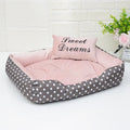 Polka dot print dog bed with a matching square pillow in grey, blue, pink, or red.