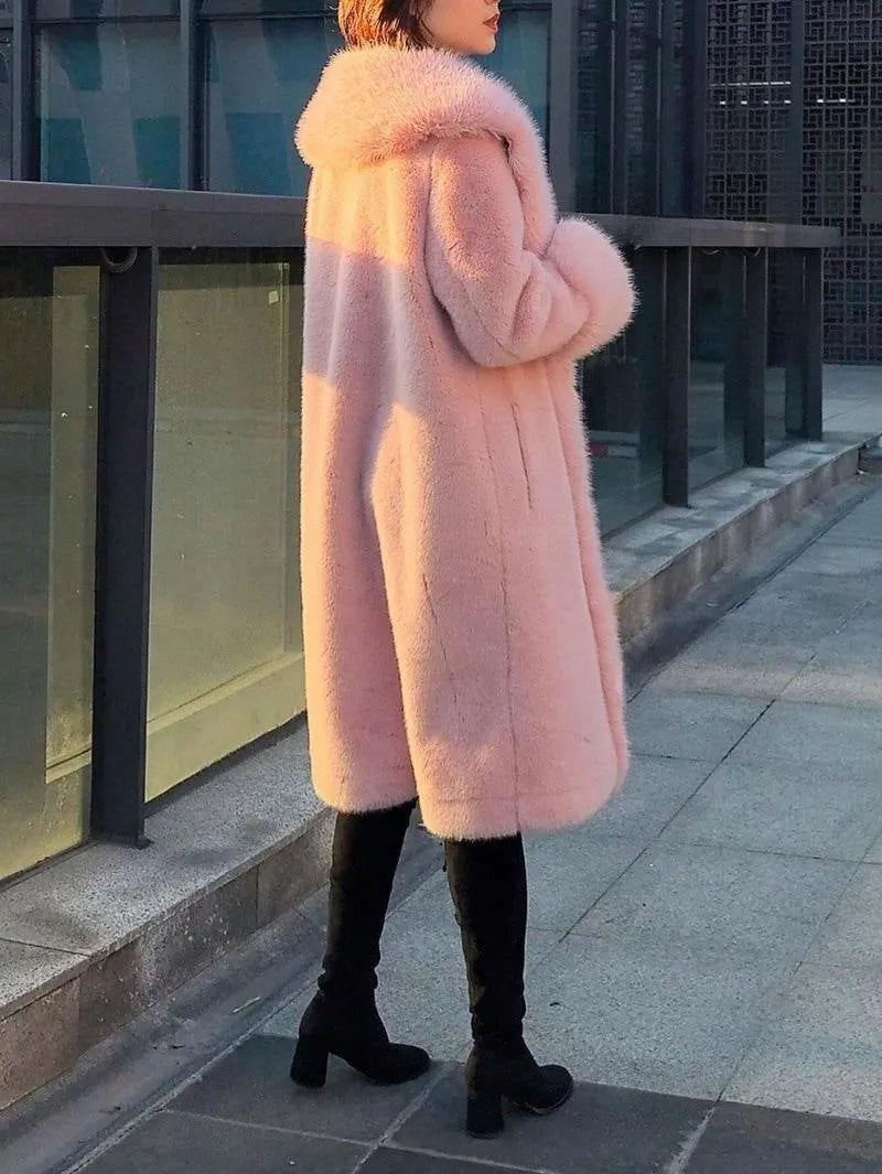 Woman wearing a grey mid-length faux rabbit fur coat with a matching fur collar.
