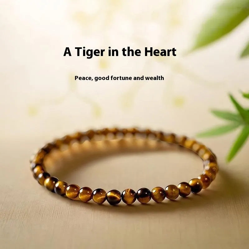 Natural tigereye gemstone bead bracelet in New Chinese geometric style on a wrist.