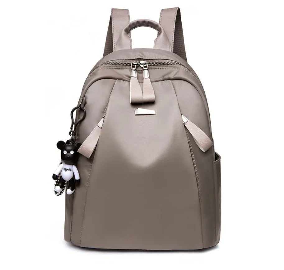Medium-sized wine red Oxford cloth rucksack with double straps and a soft handle.