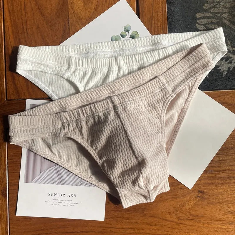 Men's solid colour cotton briefs with a mid waist and triangle design.