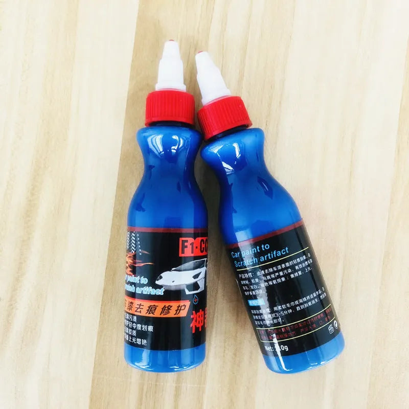 Small blue container of scratch repair agent with integrated wiping tool for automotive paint
