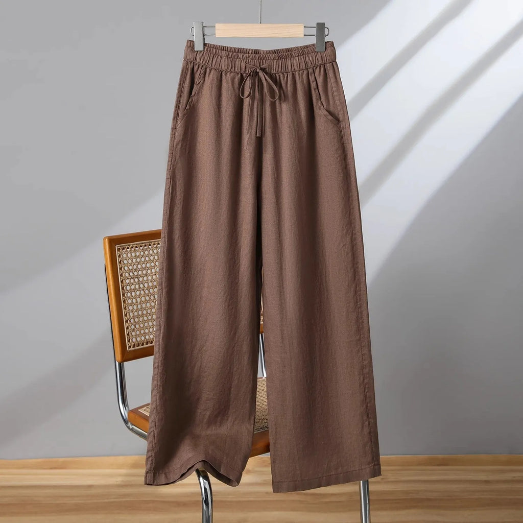 Women's straight leg casual trousers with elastic waist and lace-up drawstring detail in apricot colour.