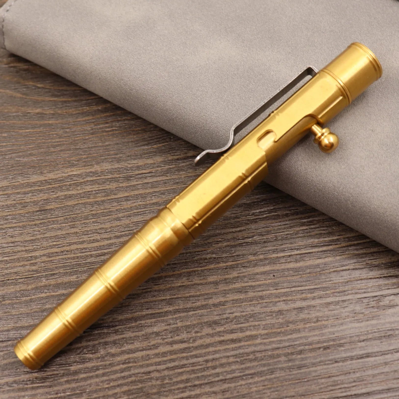 Retro brass tactical pen with bolt action mechanism in brushed natural finish