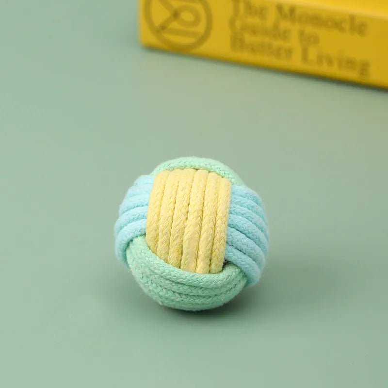Handmade cotton plush cat toy in blue pink green colours measuring 5cm diameter