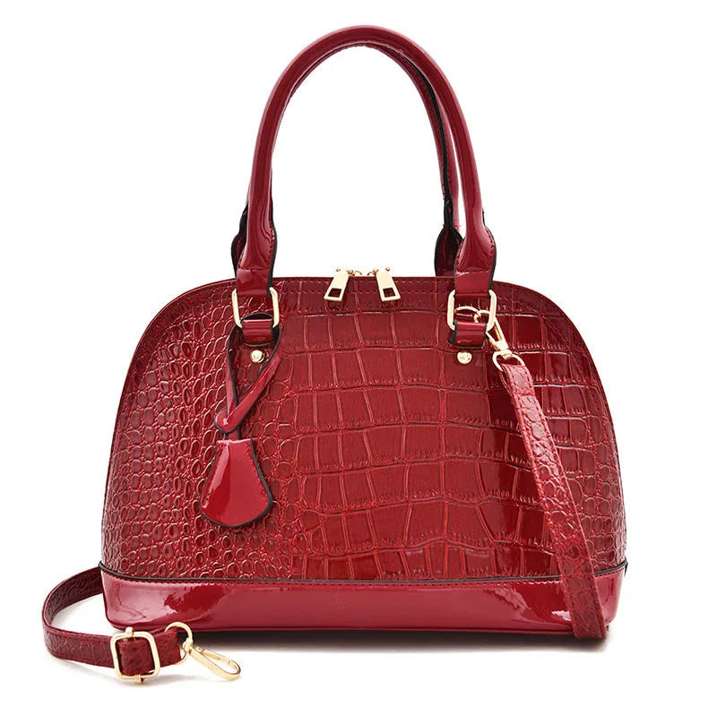 Shiny black PU leather shell-shaped crossbody bag showing its structured design and size.