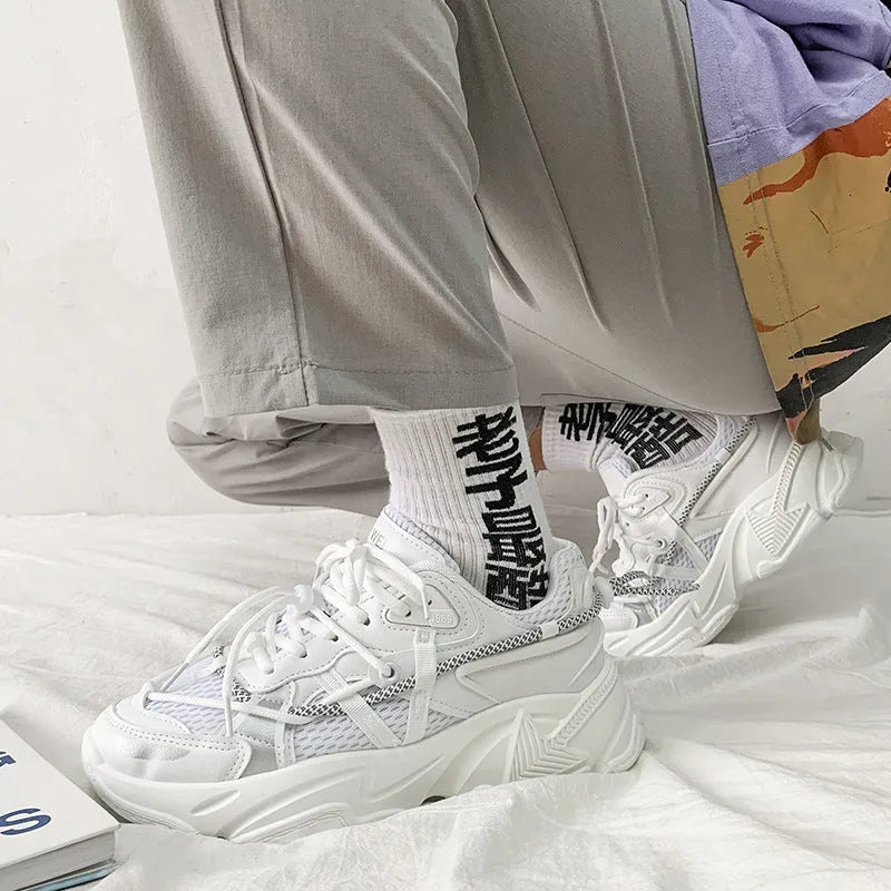 Men's white platform dad sneakers with a lace-up front and thick sole, shown on a grey background.