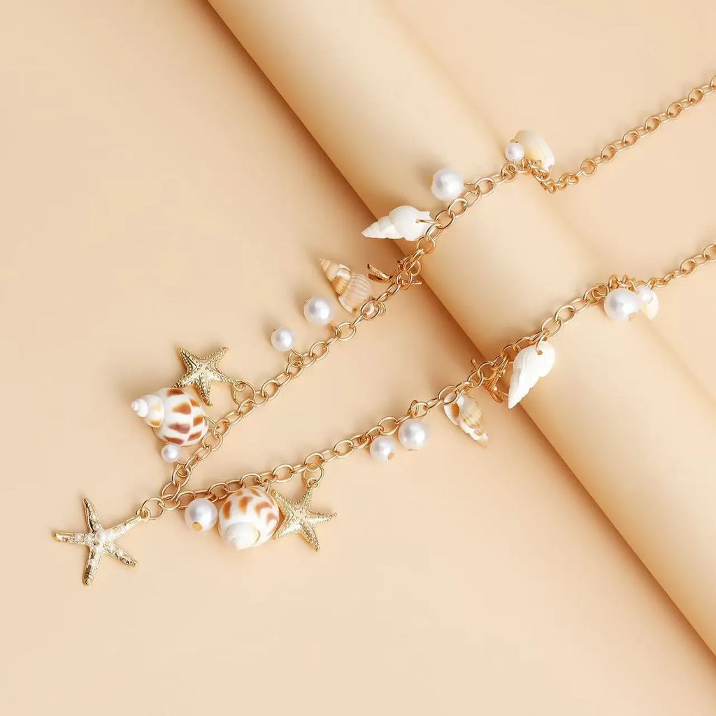 Women's alloy waist chain with star charm and matching bracelet set for summer wear.