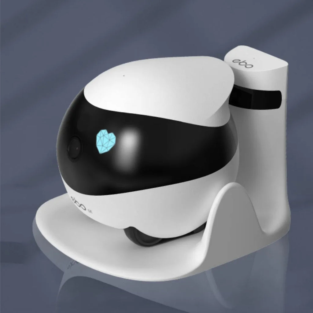 White mobile surveillance robot camera with wheels next to its automatic charging docking station