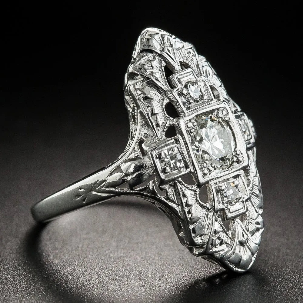 Geometric hollow out copper ring with silver electroplating and diamond stud accents on a grey background.