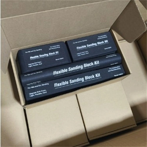 Set of seven identical black frosted metal building blocks for model making