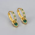 A pair of women's heart-shaped clip earrings with a coloured gemstone centre, available in gold or white gold colour metal.