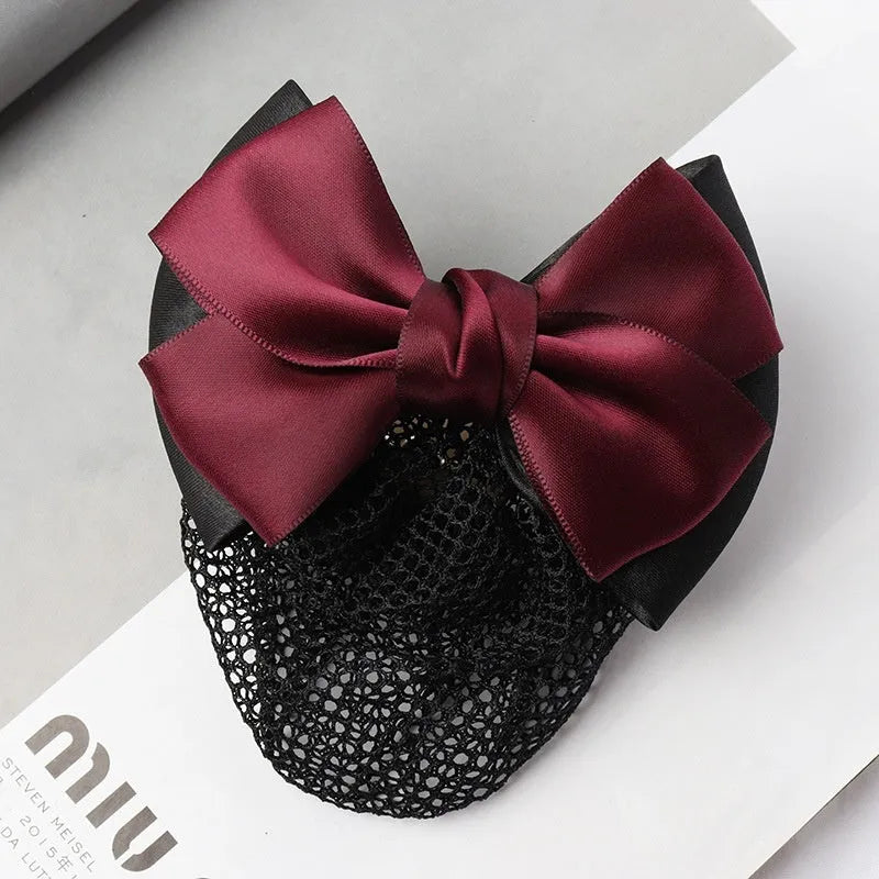 Professional flower bow headdress hair clip ornament on a work plate, shown in a selection of net and mesh colour variations.