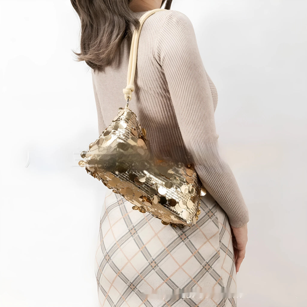 A soft polyester women's underarm crossbody bag in a metallic colour, showing sewing thread detail and a single strap.