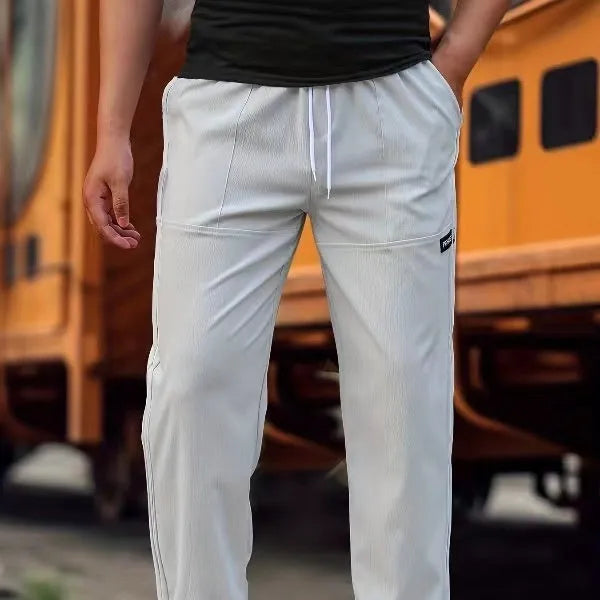 Men's lightweight polyester casual trousers in light grey colour shown flat