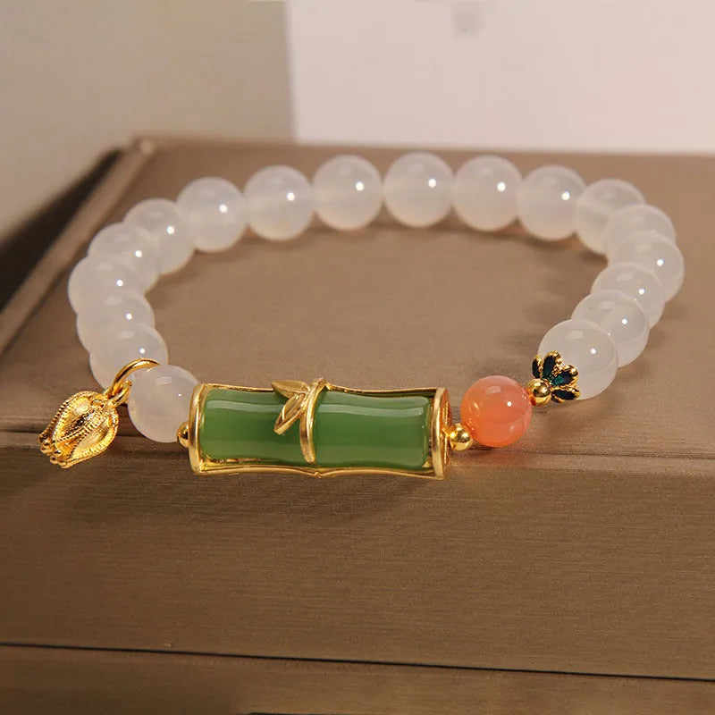 Women's white agate jasper bamboo bead bracelet with a single central jade focal bead.