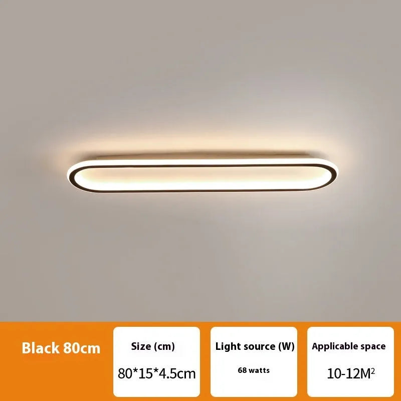 Black minimalist strip ceiling lamp mounted flush on a white ceiling.