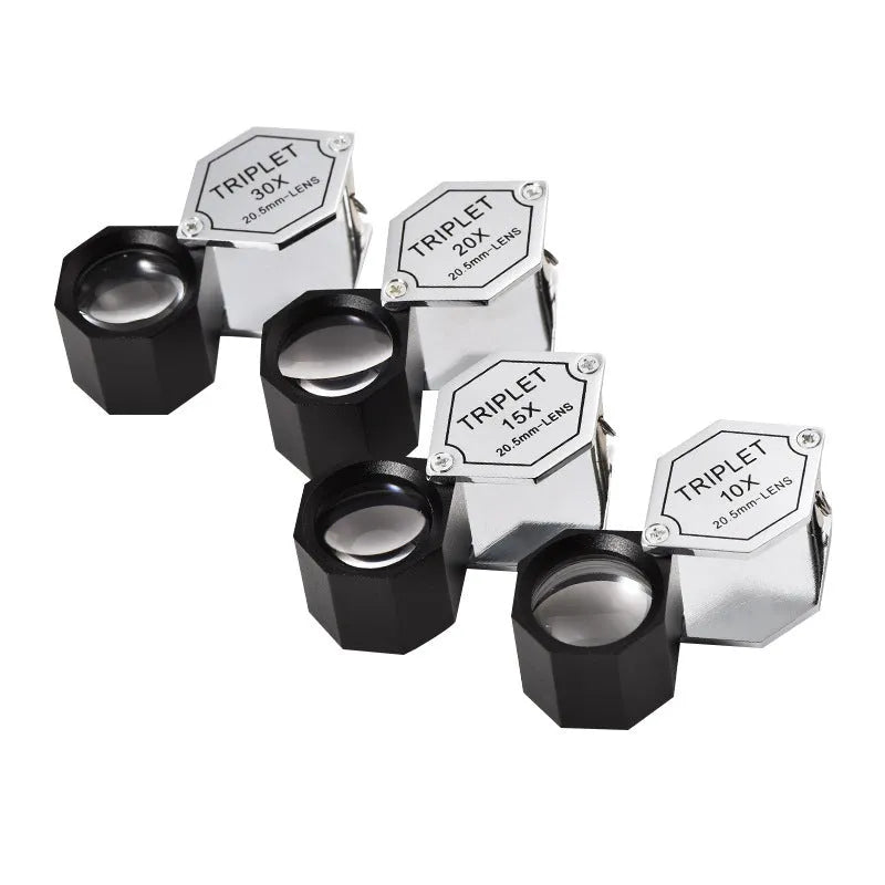 Handheld metal magnifying glass with optical lens for jewellery and stamp identification.