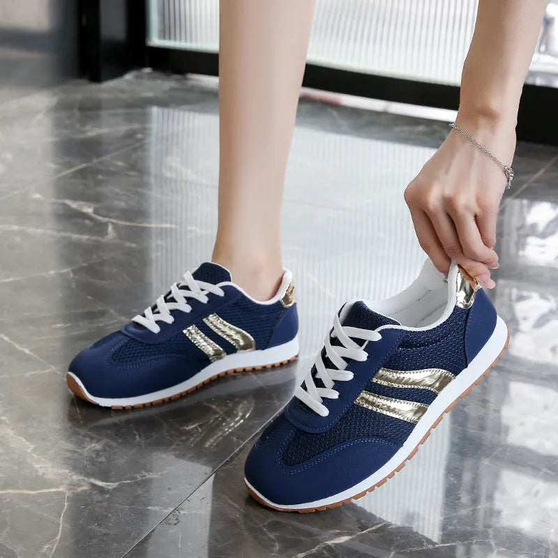 Blue women's casual sports shoes with lace-up front, cross shoulder straps, and a flat non-slip rubber sole.