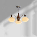 Persimmon glass and chrome chandelier with multiple lampshades in a Middle Ancient style