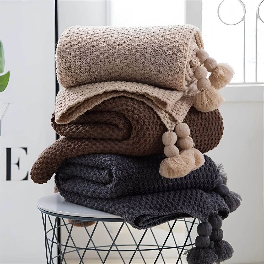 Nordic fringed knit ball acrylic blanket in beige colour showing texture detail and 130x170cm size