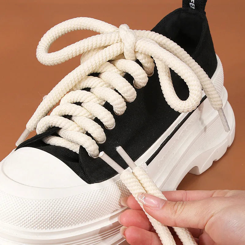 Pair of round woven shoelaces in white next to a ruler showing 10mm diameter and length scale.