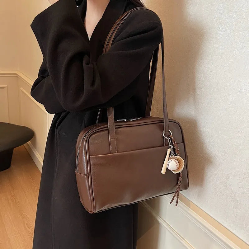 Women's urban simple PU bucket underarm bag with pendant detail in black, brown, coffee, and wine red colours.