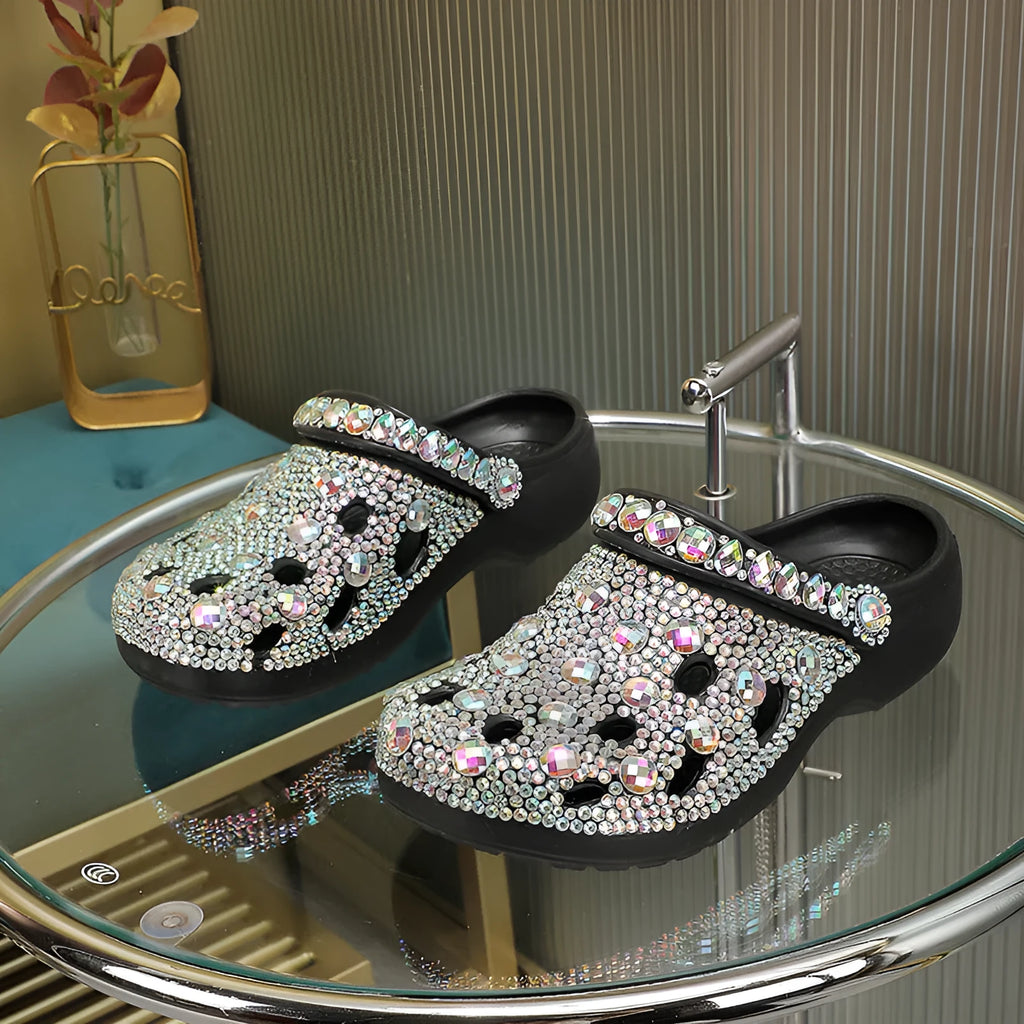 Black women's platform sandals covered in rhinestones with a chunky EVA sole.