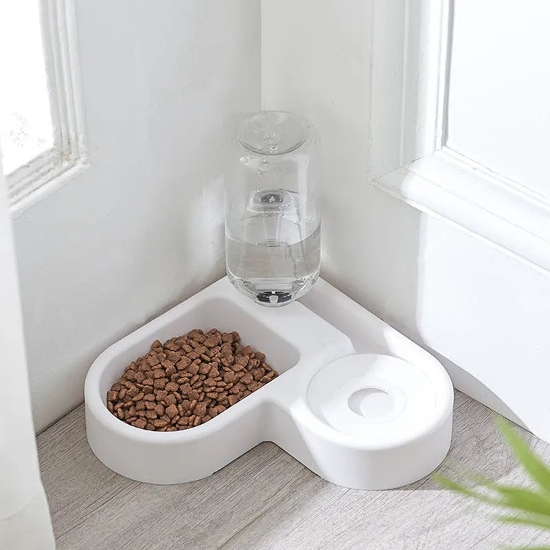 White automatic pet water fountain with stainless steel top on a floor.