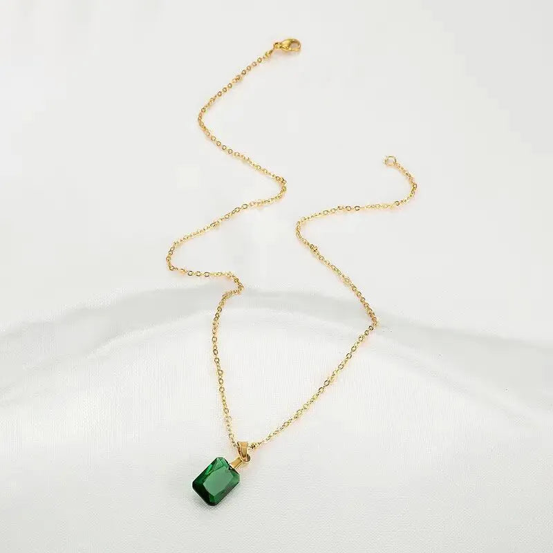 Rectangular copper pendant necklace with geometric quadrilateral design and green finish on O-ring chain.
