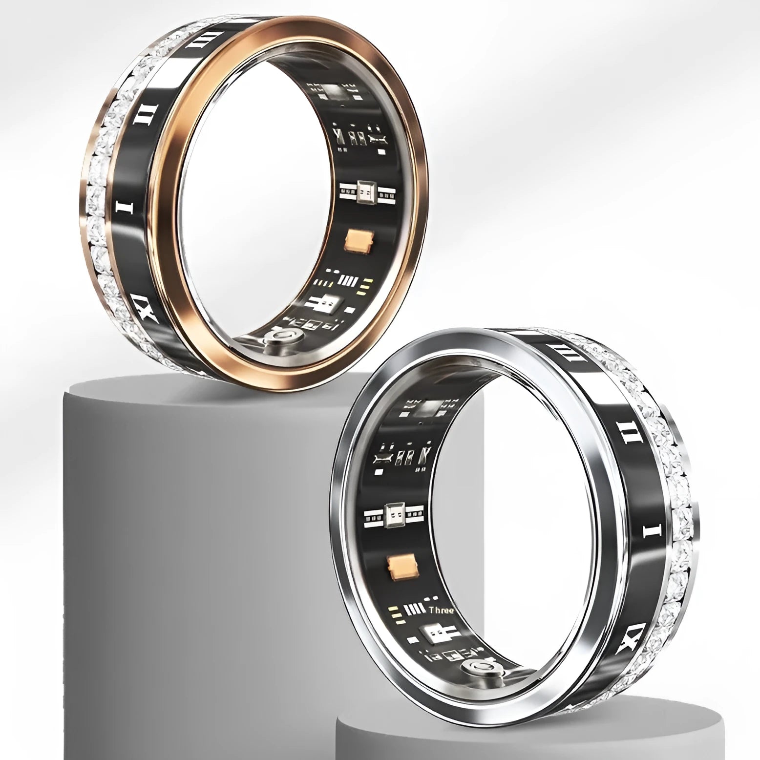 Gold and silver smart rings with diamond inlays displaying blood oxygen monitoring technology on a finger.