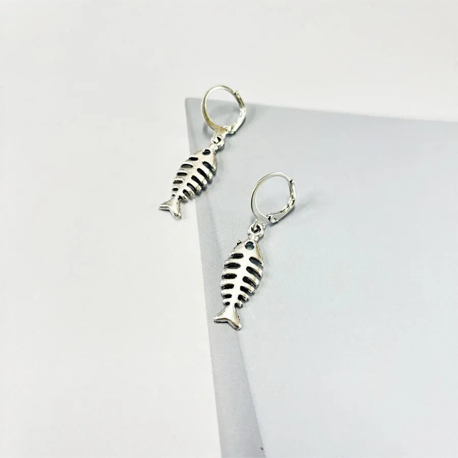 Fishbone pendant necklace and earrings set with adjustable chain on white background