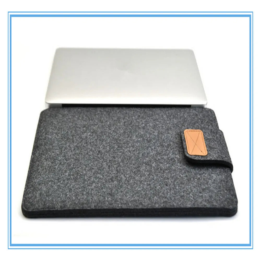 Dark grey clamshell laptop bag open to show interior laptop compartment and corner protector.