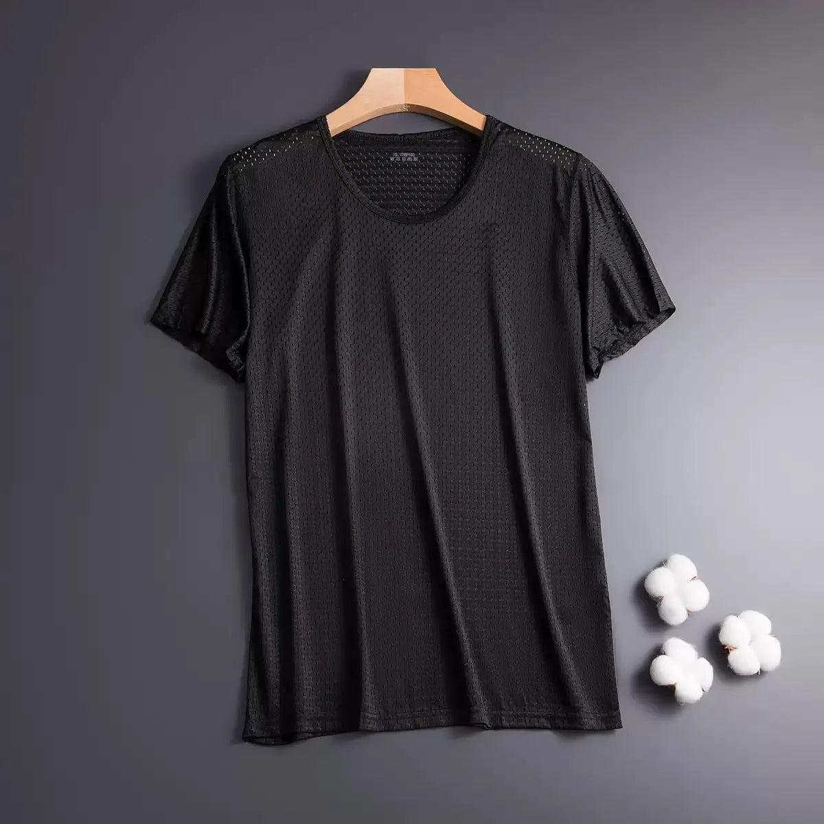 Man wearing a loose-fit ice silk short sleeve T-shirt in a solid colour.